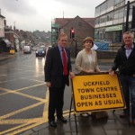 Cllr Chris Dowling, East Sussex County Council member for Ridgewood and Framfield, Cllr Claire Dowling, county council member for Uckfield and member of the project board and Uckfield town mayor Ian Smith, with one of the new signs reinforcing the message that Uckfield town centre is open as normal