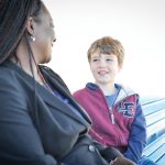 Stock image of child talking to adult