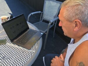 man sitting in front of a laptop computer