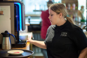 girl working coffee machine