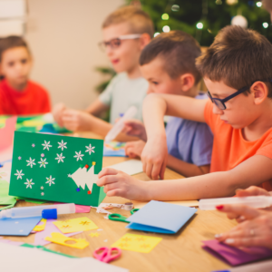 children at a table making Christmas crafts