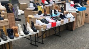 market stall with shoe boxes with shoes on top on them