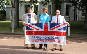 L - R Cllr Peter Pragnell - Chairman of the County Council, Becky Shaw - ESCC Chief Executive, and Cllr Bob Bowdler - Lead Member for Children and Families holding the Armed Forces Flag