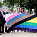 Representatives from organisations in East Sussex holding the pride flag