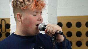 Boy singing into a microphone