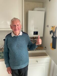 Man standing in front of a new boiler 