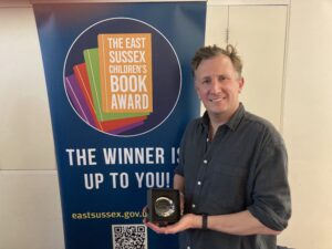 winning author Tom Vaughan holding his trophy