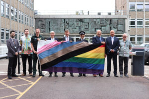 People holding the Pride flag outside County Hall 